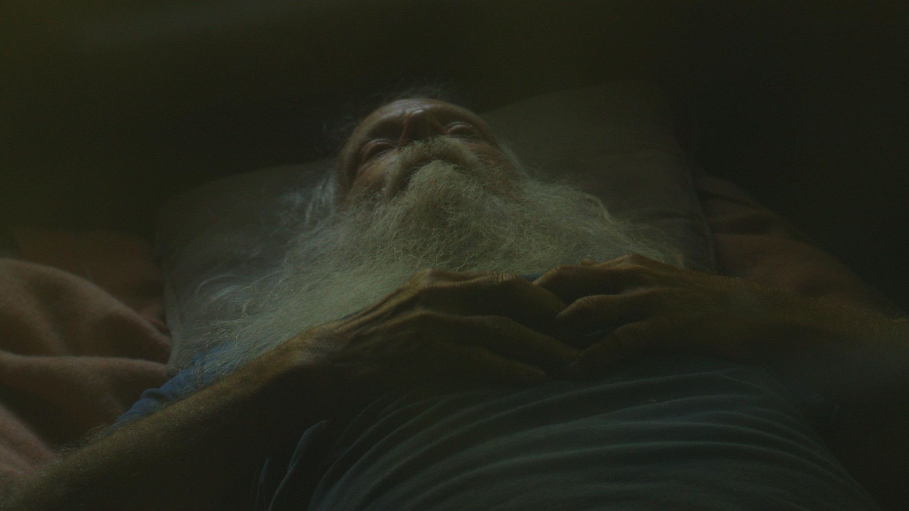 A reclining bearded man in Brenda Xu’s Flying