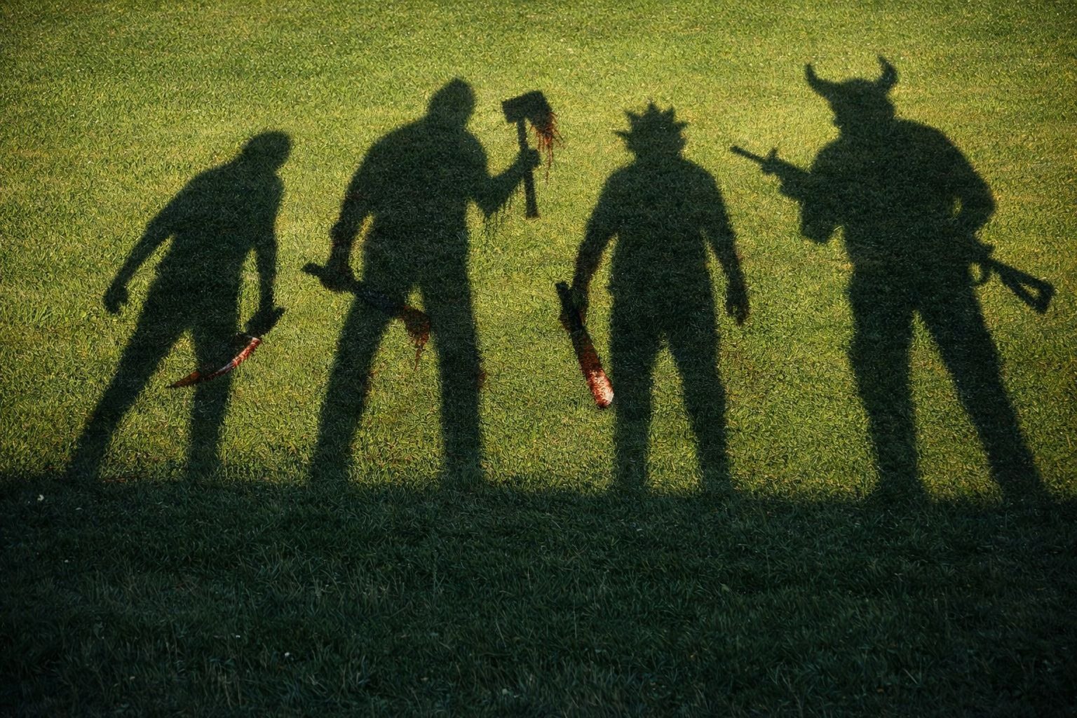 Maniacs development artwork showing four armed shadows across a lawn